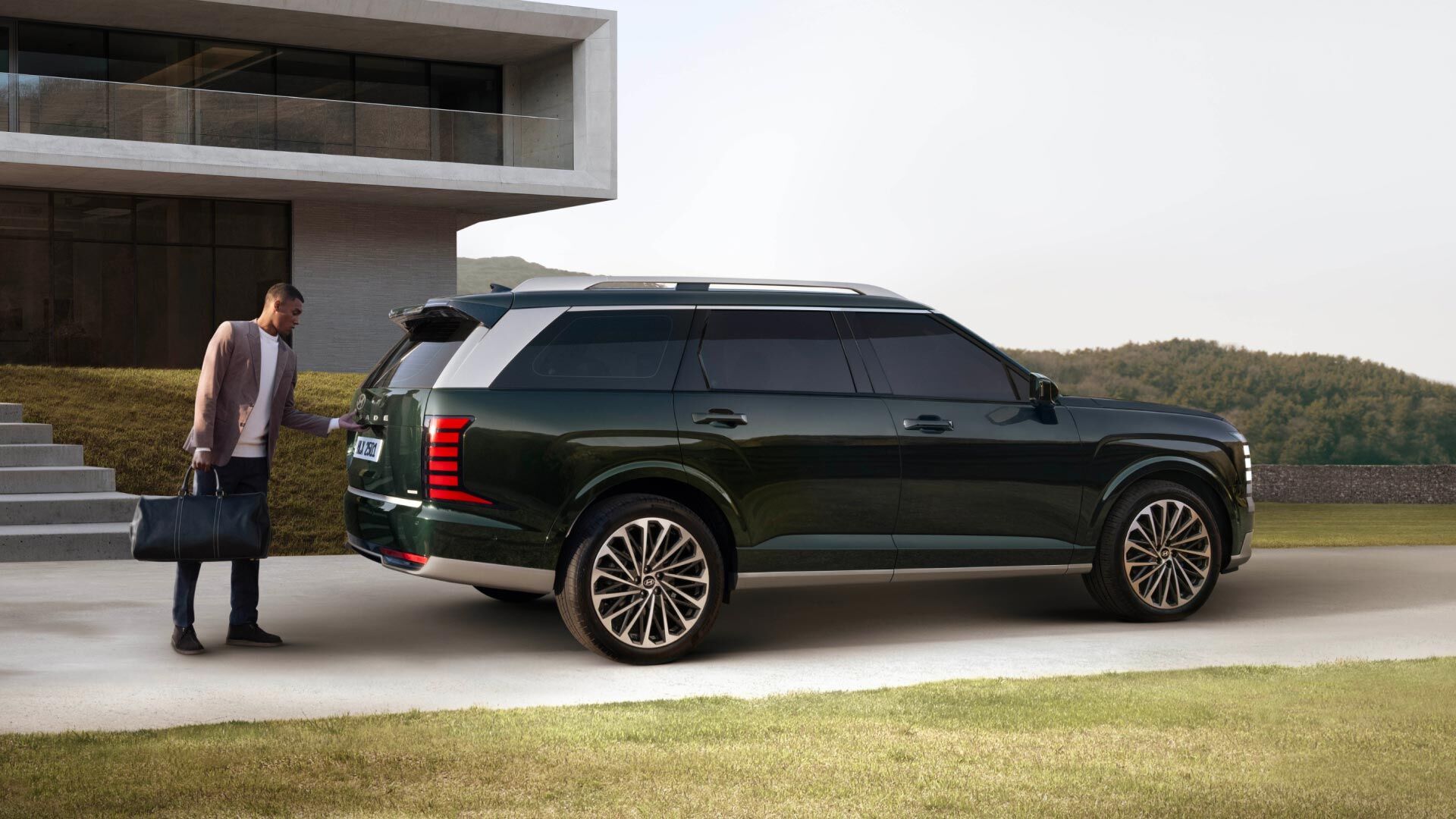 Side-front view of orange Grandi10 with lakeside view at night